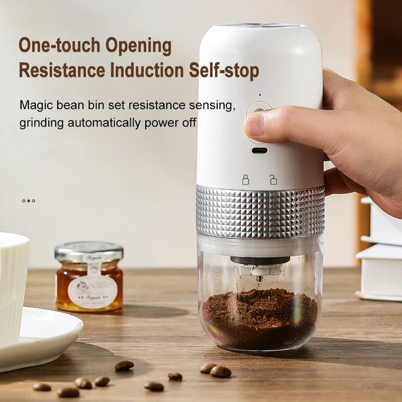 White portable electric coffee bean grinder with silver textured grip, clear container, and one-touch power button.