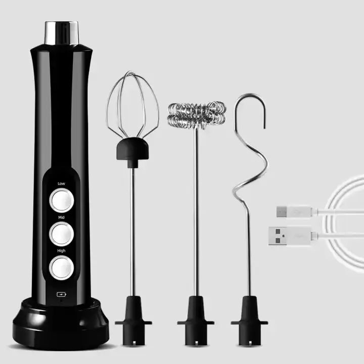 Black handheld electric milk frother with 3 speed settings, charging base, three whisk attachments, and USB cable.