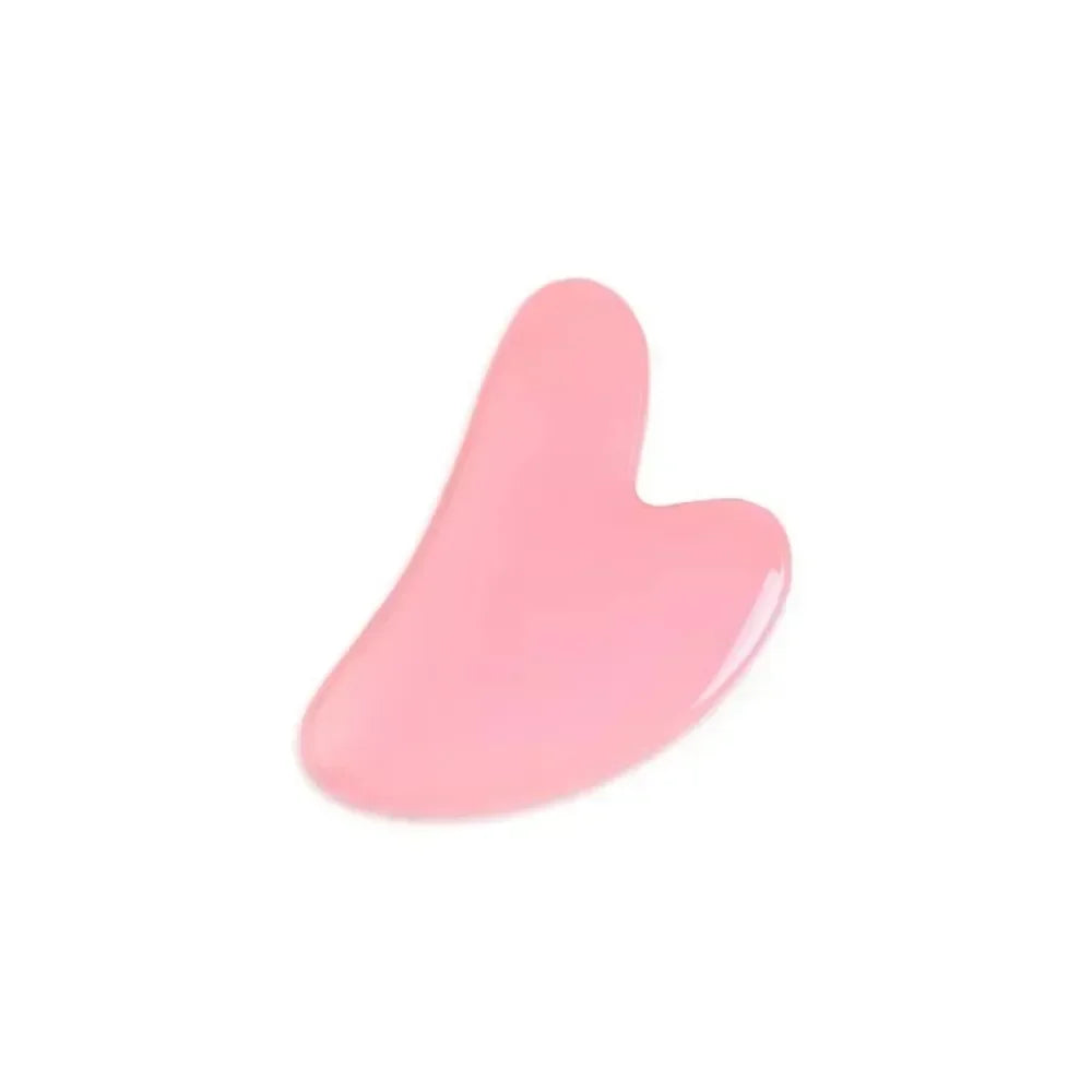Pink heart-shaped resin gua sha scraper for facial massage, anti-wrinkle treatment, and natural skin lifting.
