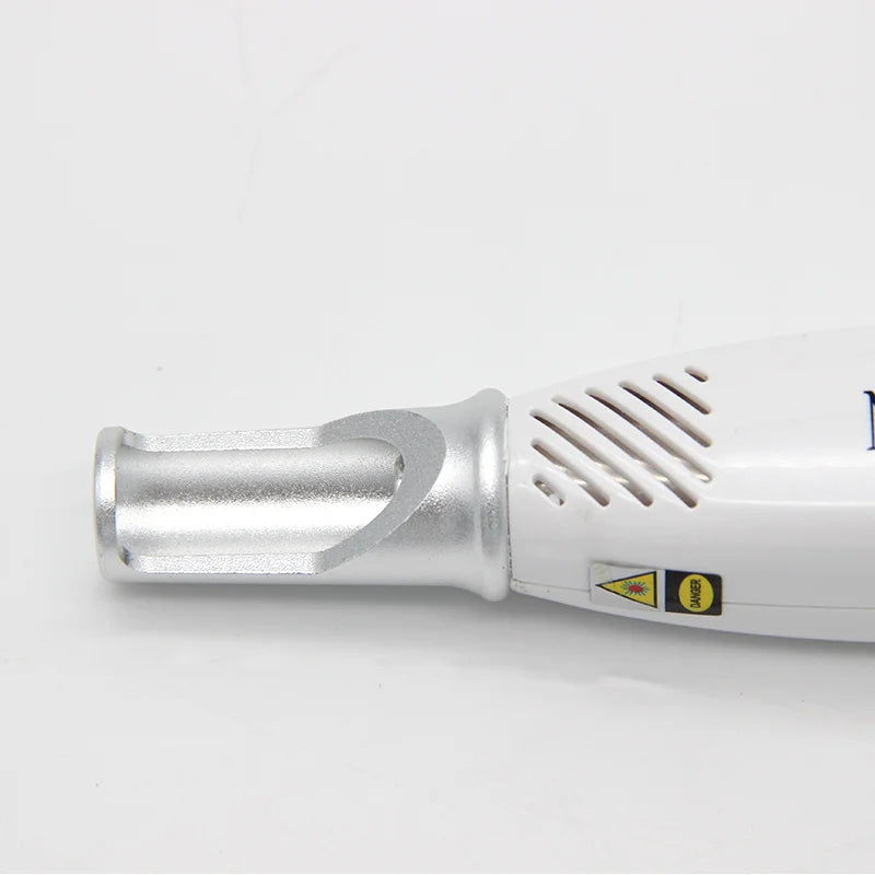 White handheld picosecond laser pen for facial skin pigment, tattoo, and acne scar removal with metallic treatment tip.