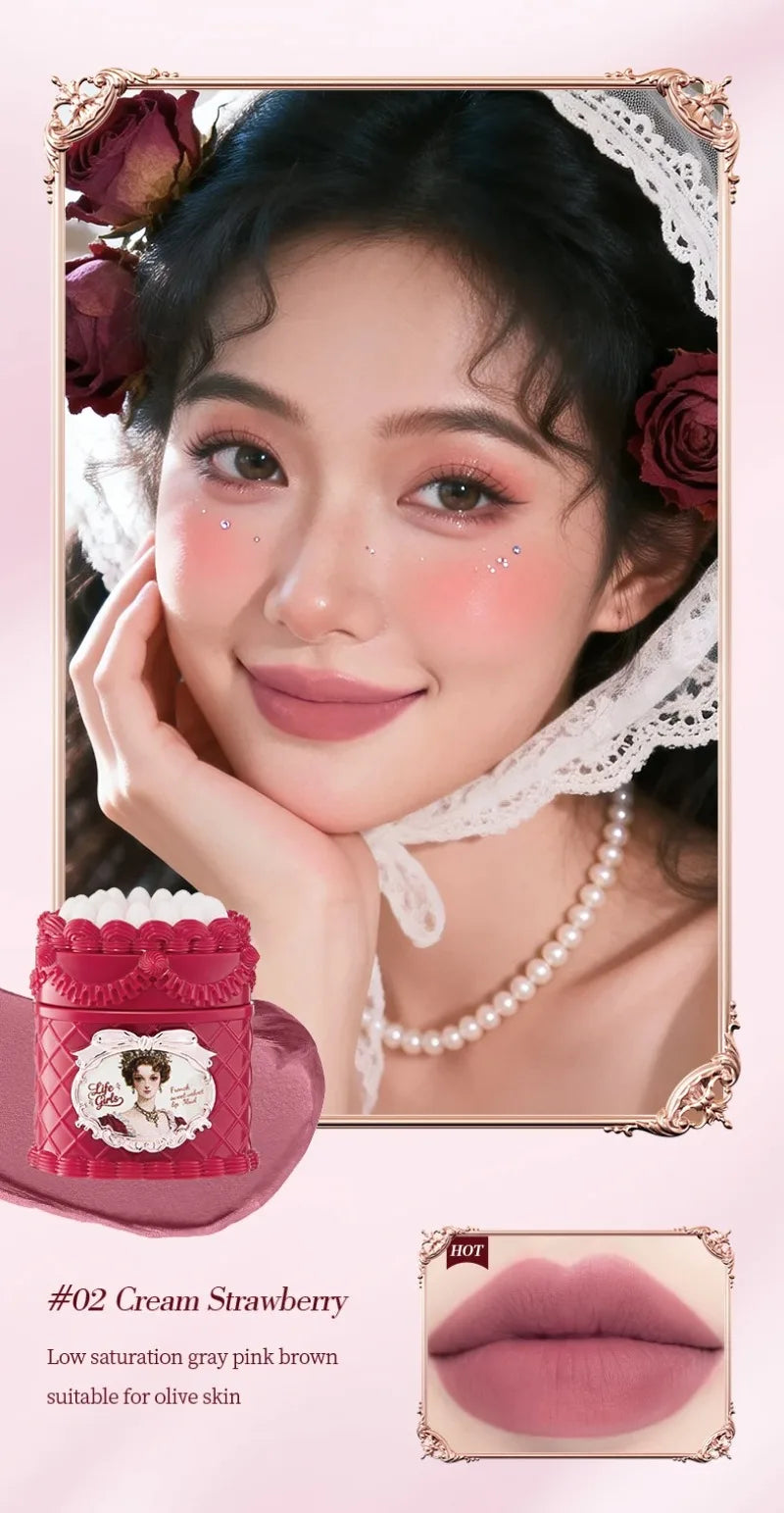 Model wearing strawberry cream matte lip mud, a soft-focus gray pink-brown highly pigmented velvet mousse lipstick.