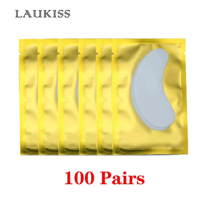 White lint-free under-eye gel patches for eyelash extensions in shiny gold individual foil sachets.