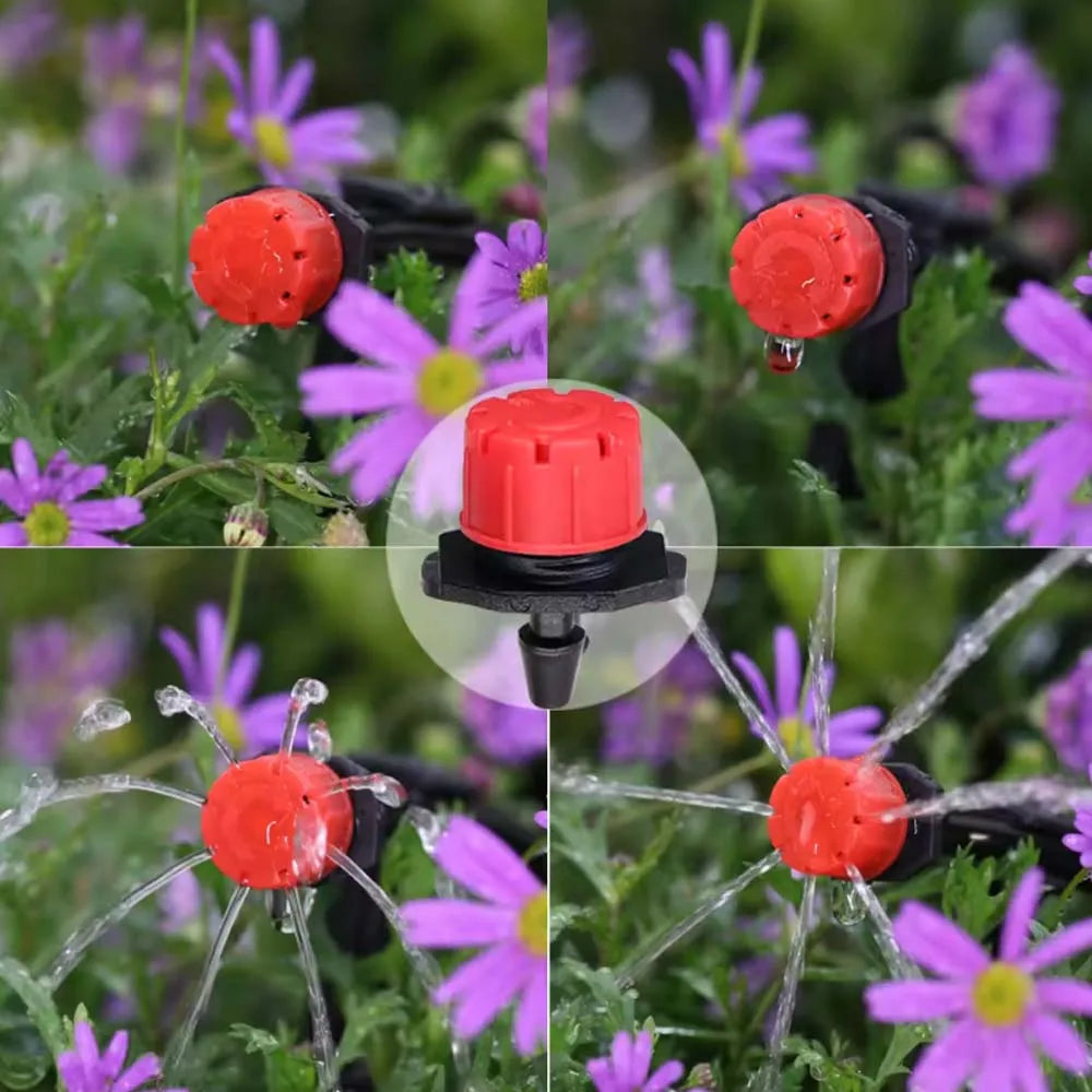 Orange sprinkler emitters attached to black tubing over purple flower bed