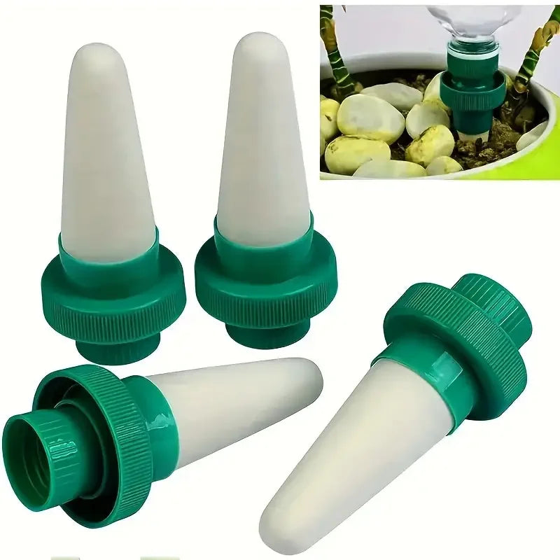 Set of four plant drip irrigation stakes with white spikes and green ribbed caps.