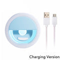 Light blue circular clip-on LED selfie ring light with an included micro-USB charging cable.