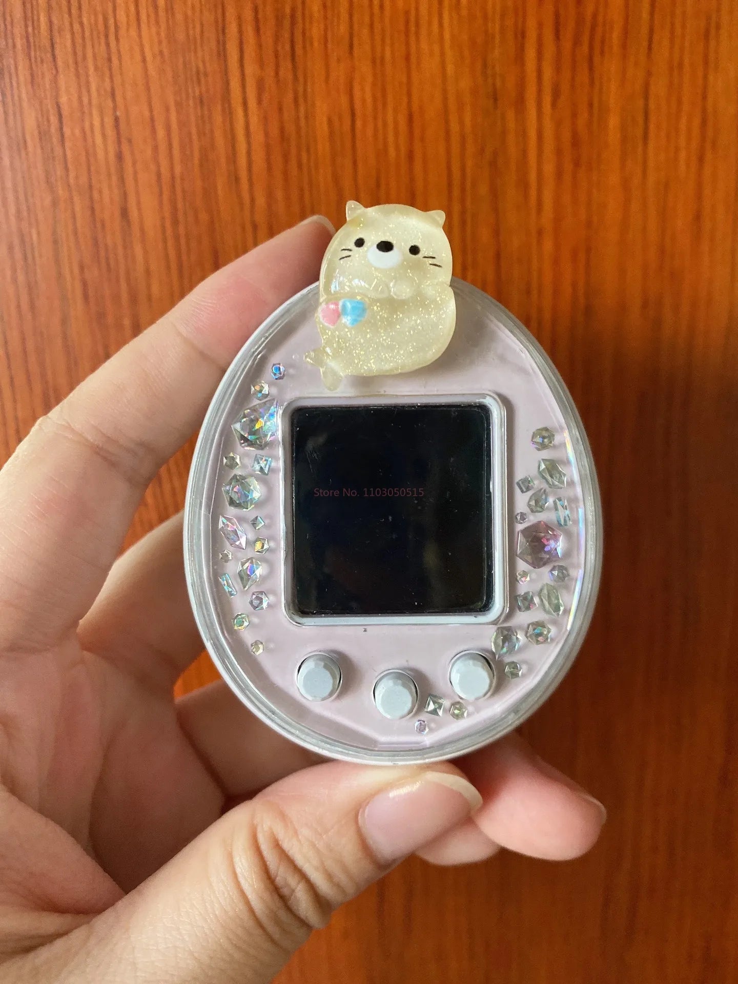 Tamagotchi Uni glitter heart plug dust cover with sparkling rhinestones for cute, protective electronic pet customization.