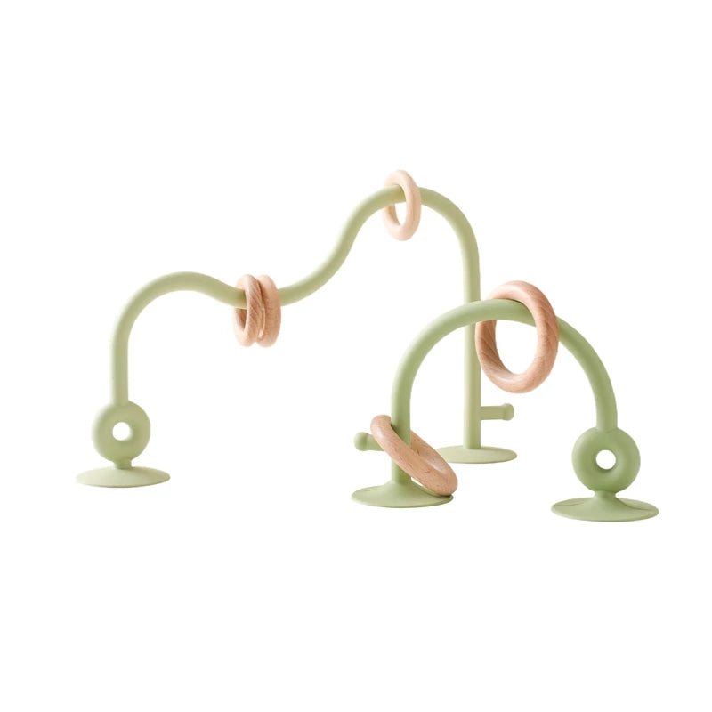 Sage green silicone and natural wood baby teething toy rings for soothing infant teething relief.