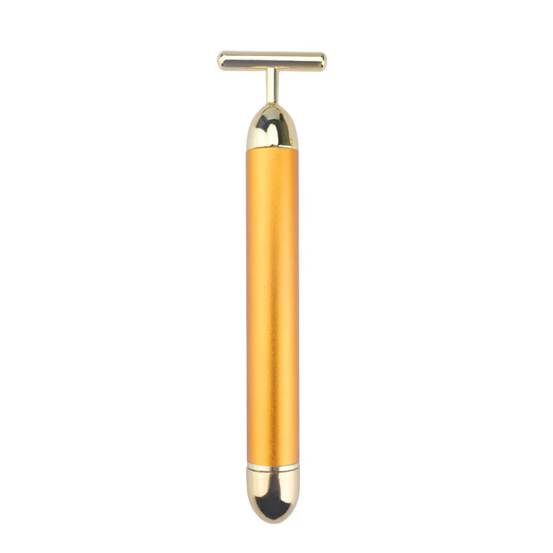 Gold T-bar facial massager with a matte metallic handle and shiny gold accents, isolated against a white background.