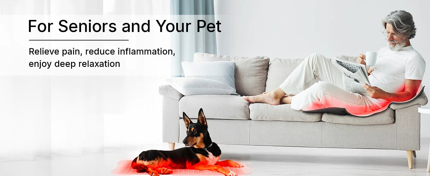 Large flexible red light therapy mat glowing red under a man on a sofa and under a dog on the floor.