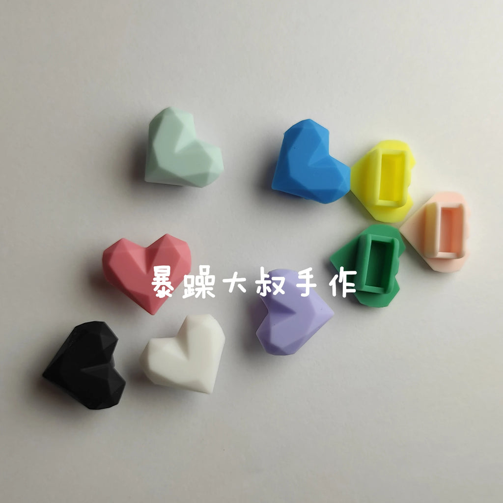 Colorful heart-shaped silicone dust plugs for Tamagotchi Uni, perfect for protecting ports from dirt and debris.