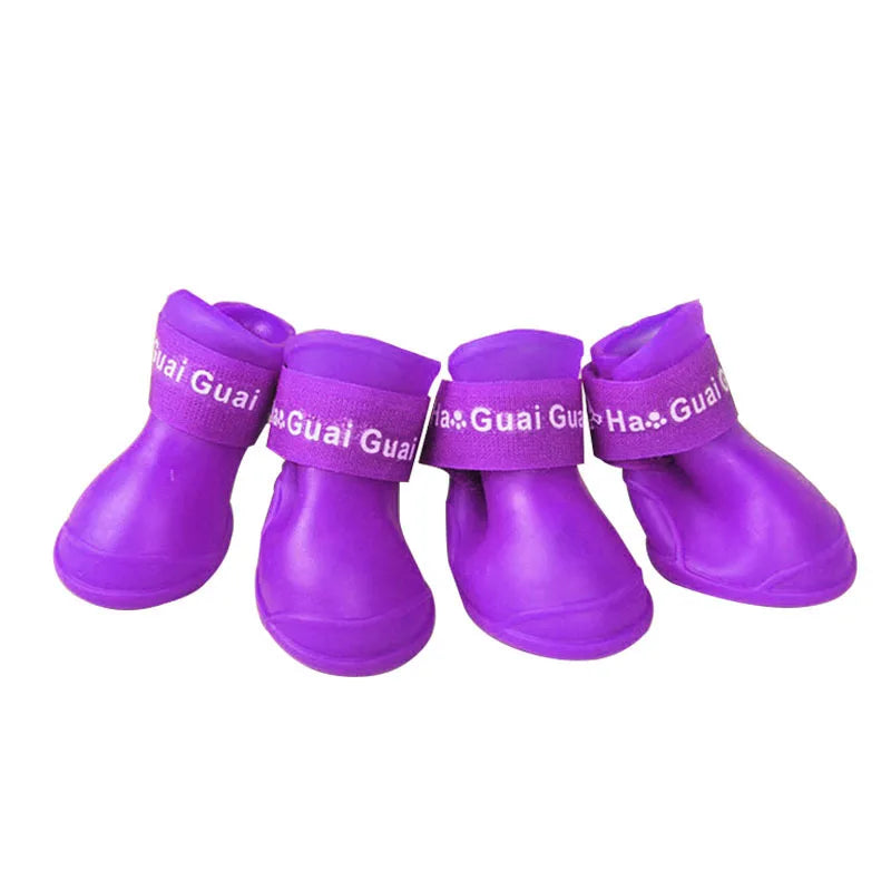 Purple waterproof non-slip dog rain boots with secure velcro straps for dry, protected pet paws during outdoor walks.
