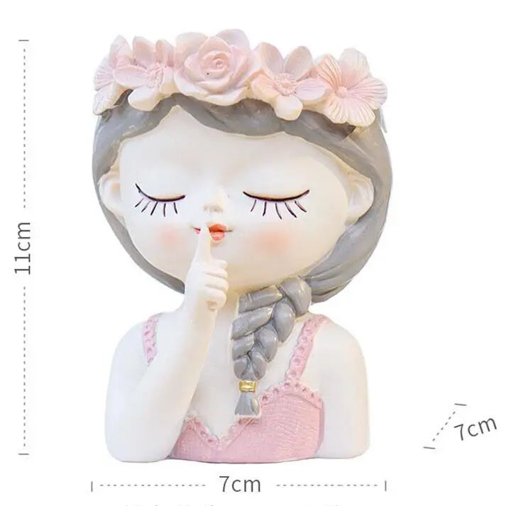 Child-face succulent planter with flower crown and hand near mouth