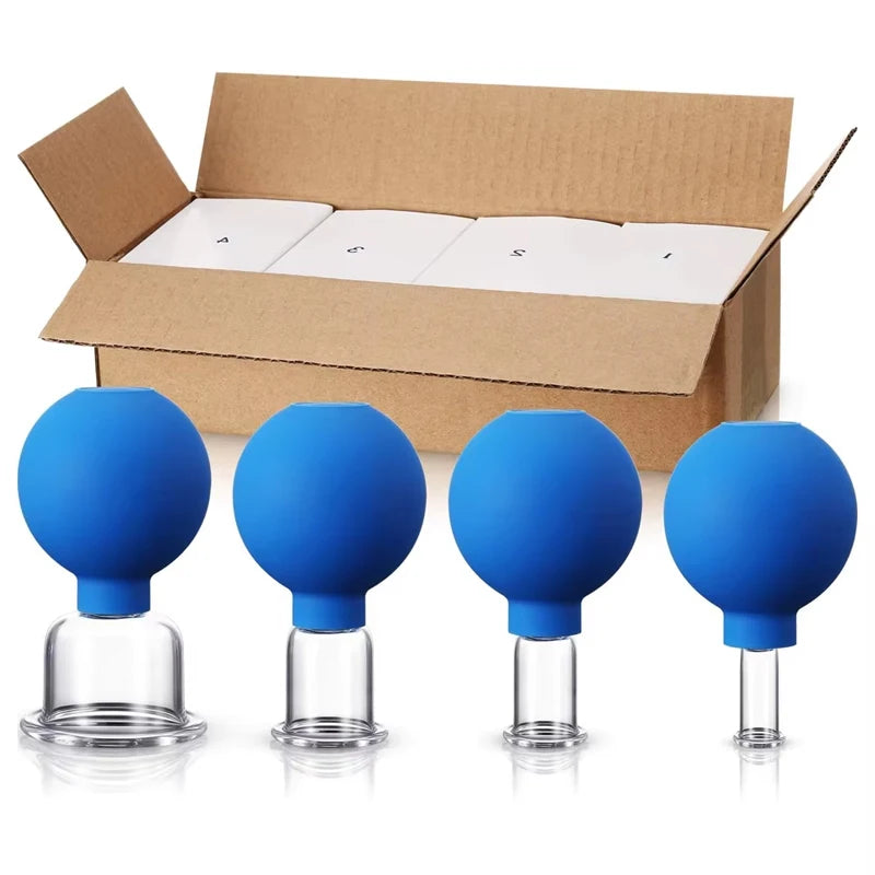 Four blue rubber bulb vacuum cupping tools with clear glass bases of varying widths, arranged before an open brown box.