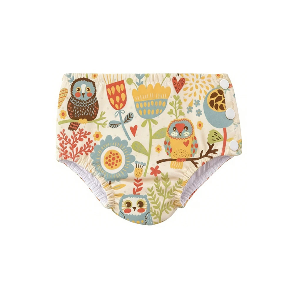 Reusable baby swim diaper with snap sides and cute owl and floral print design. Baby care essential.