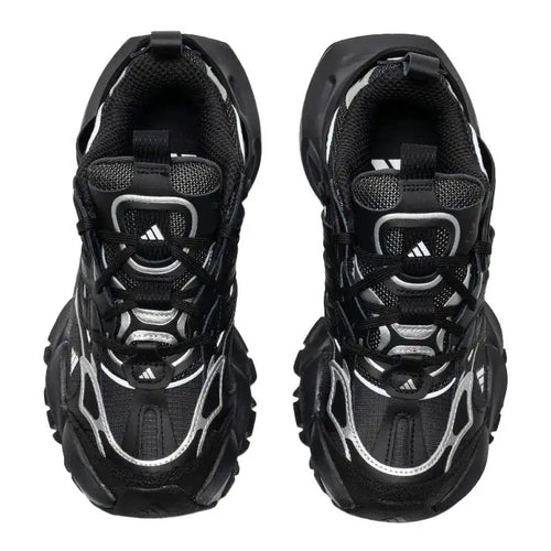 Adidas XLG Runner sneakers in black and silver, featuring mesh and synthetic overlays with chunky cushioned soles.