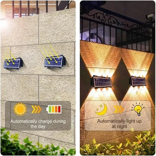 Two black rectangular solar wall spotlights mounted on an outdoor brick wall, glowing upward and downward.