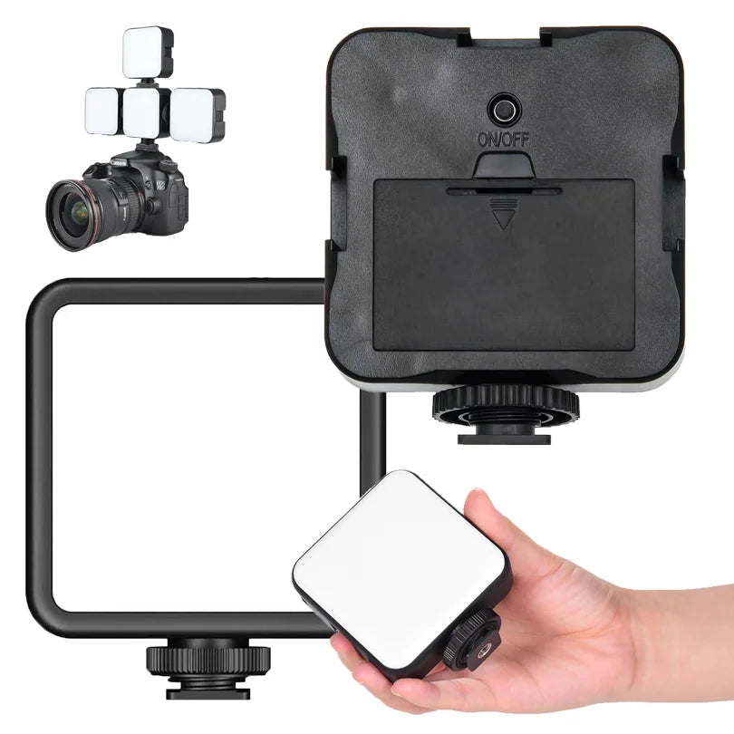 Square LED camera video light with hot shoe mount for photography and vlogging, shown in black housing with hand.