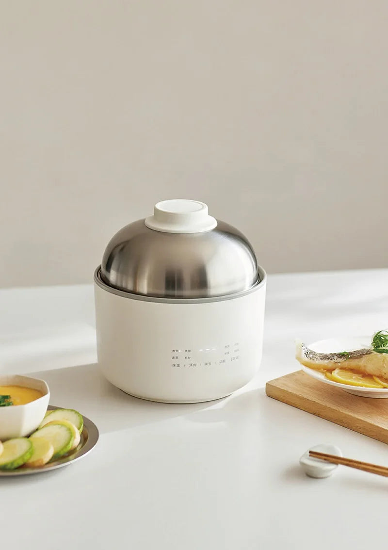 Smart white mini rice cooker with stainless lid, shown on a kitchen counter