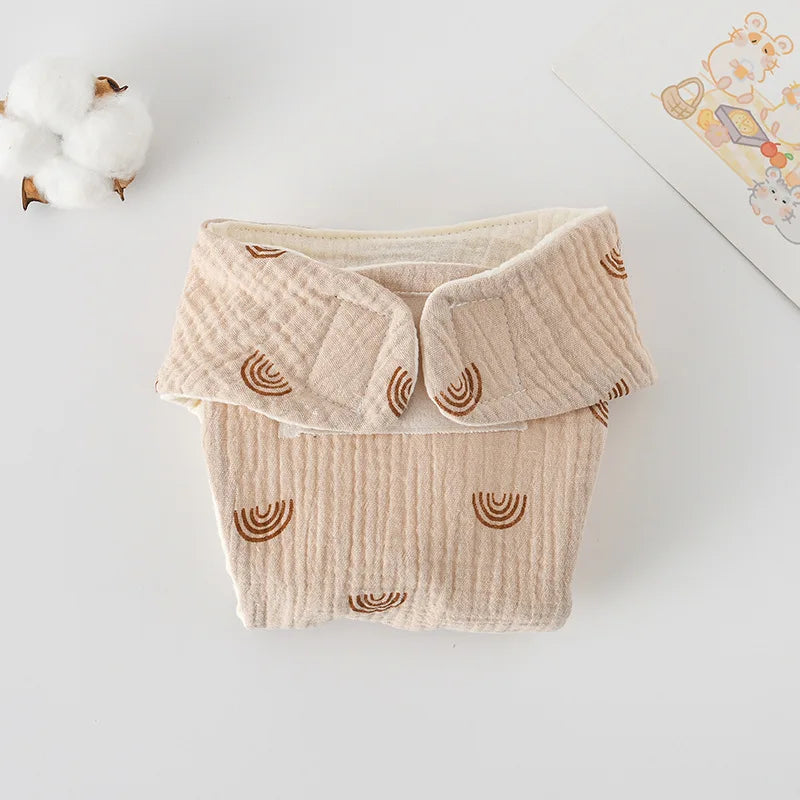 Beige muslin cloth baby diaper with brown rainbow print and adjustable wrap closure. Soft newborn baby care accessory.
