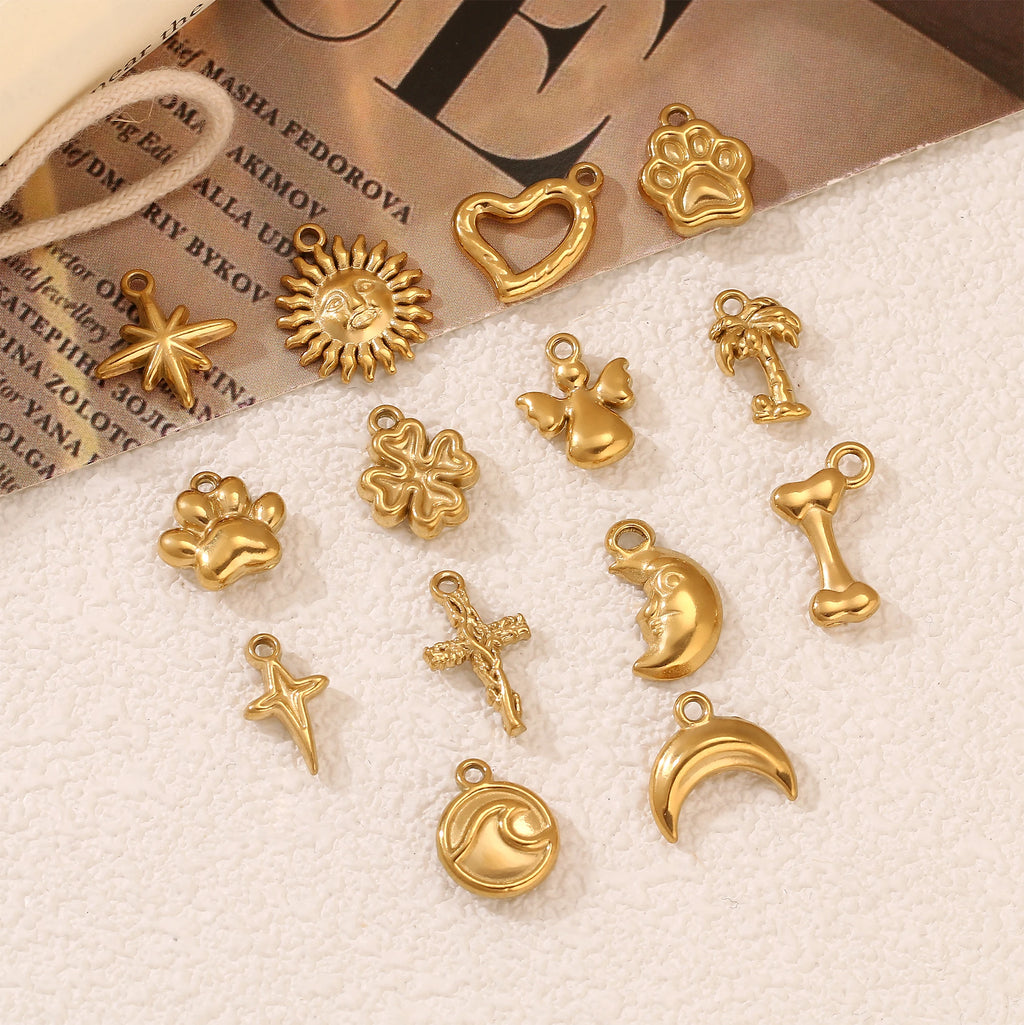 Gold stainless steel pet-themed charms including paw, star, and wave designs for DIY jewelry making and pet necklaces.