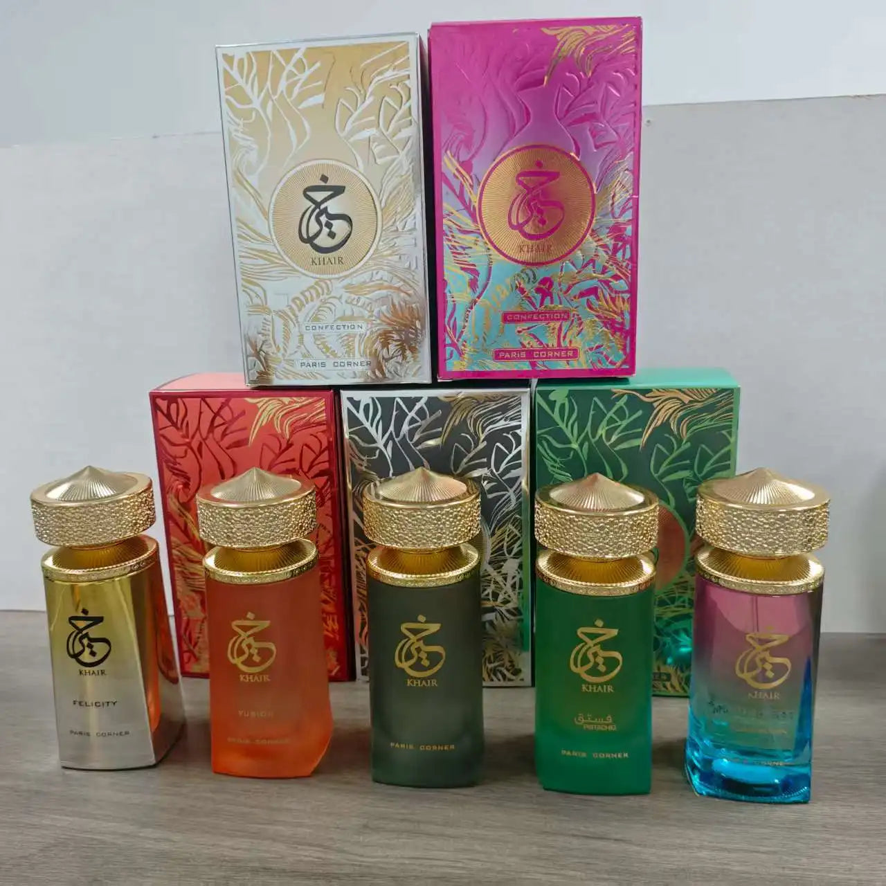 Paris Corner Khair collection EDP perfumes: colorful glass bottles with gold textured caps for women and unisex scents.