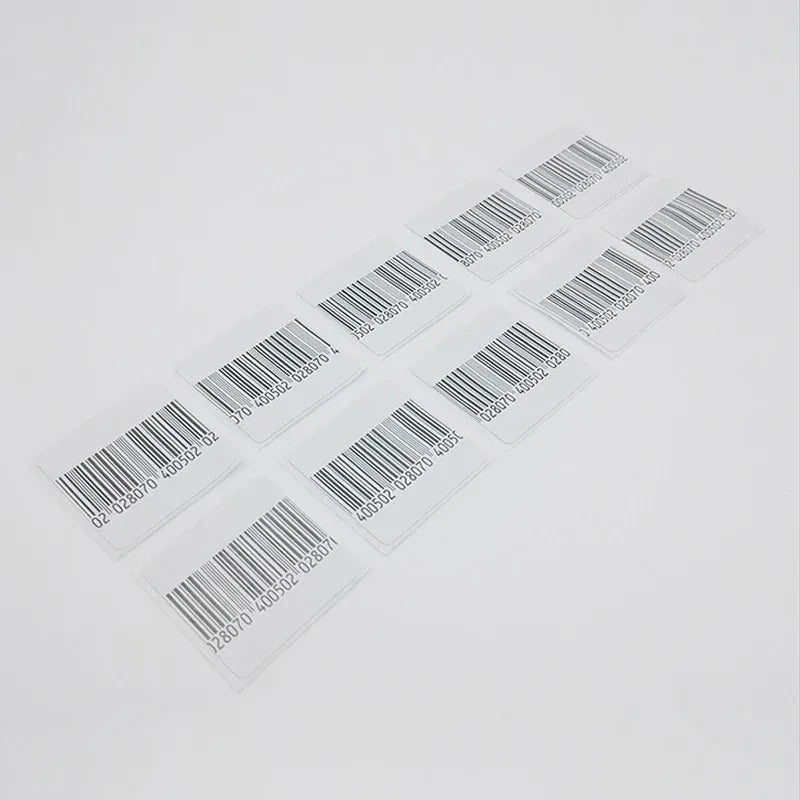Sheet of RF EAS barcode soft labels with black bars on small rectangular tags