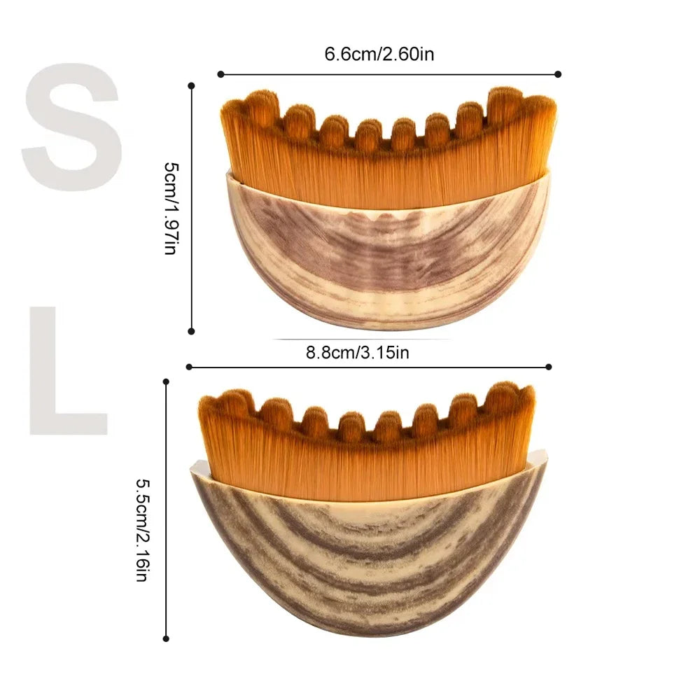 Two crescent-shaped facial massage brushes with brown wood-grain handles and textured, golden-brown bristles.