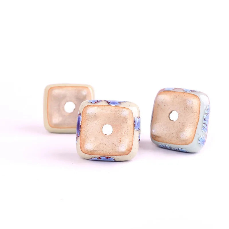Three mini ceramic succulent pots, beige and blue-purple glazes with square holes