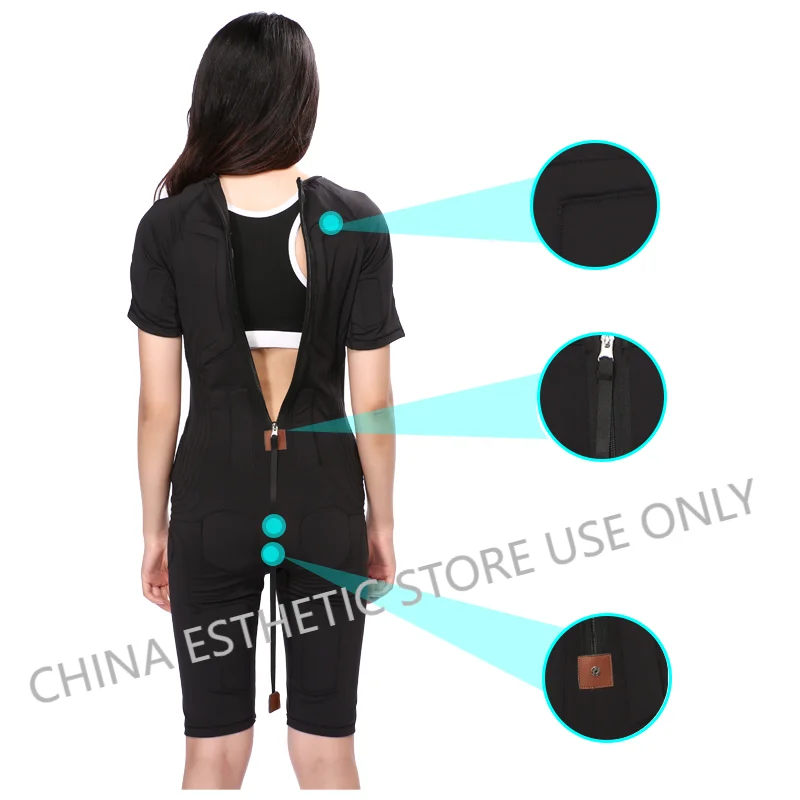 Woman wearing black wireless EMS fitness training suit with back zipper detail for muscle stimulation home gym workout.