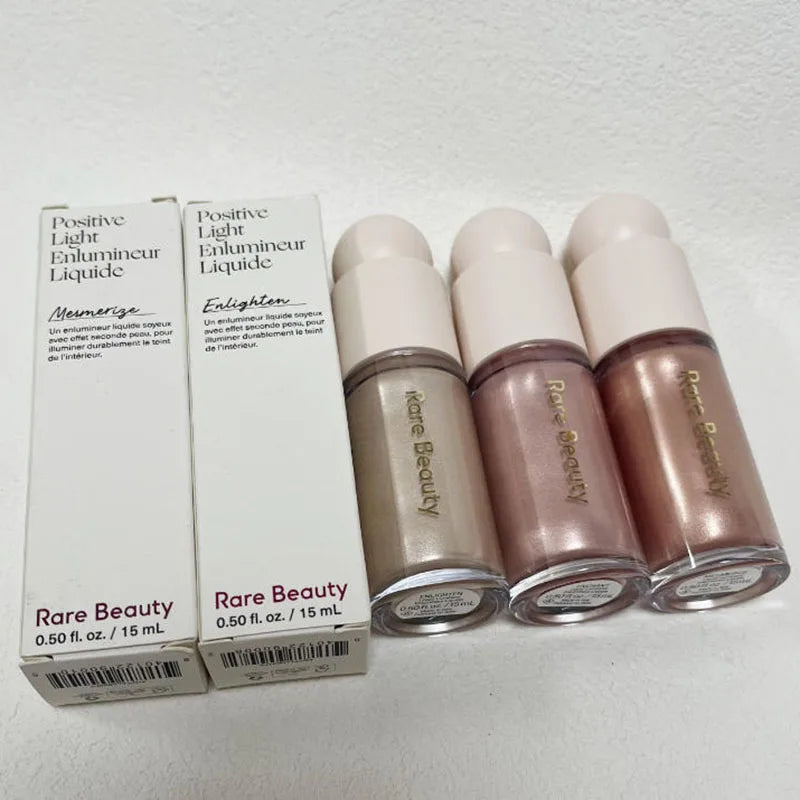 Rare Beauty Positive Light Liquid Luminizer set featuring three shimmering, silky highlight shades in glass bottles.