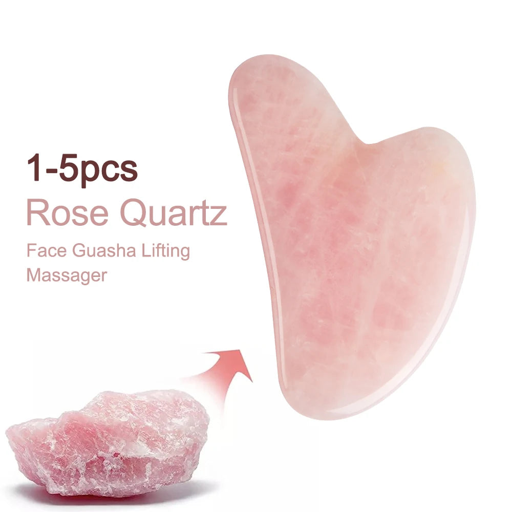 Heart-shaped rose quartz gua sha facial massage tool shown next to a piece of raw pink rose quartz crystal.