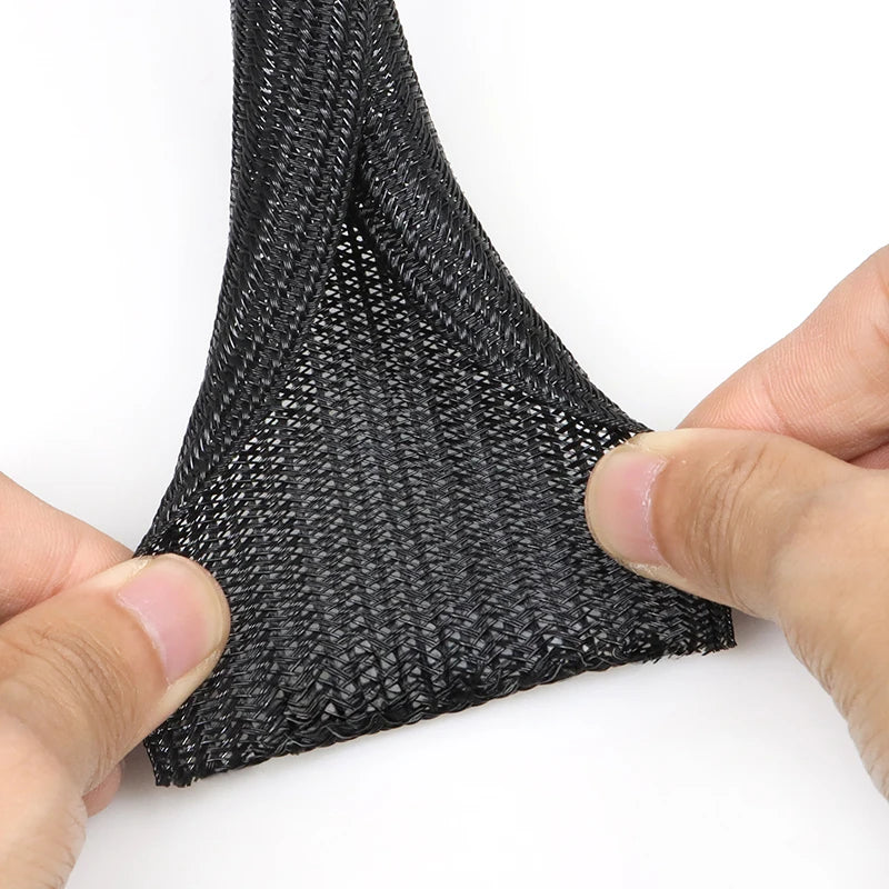 Black self-closing PET cable sleeve for wire protection. Heat-resistant, split-loom design to prevent pet chewing.