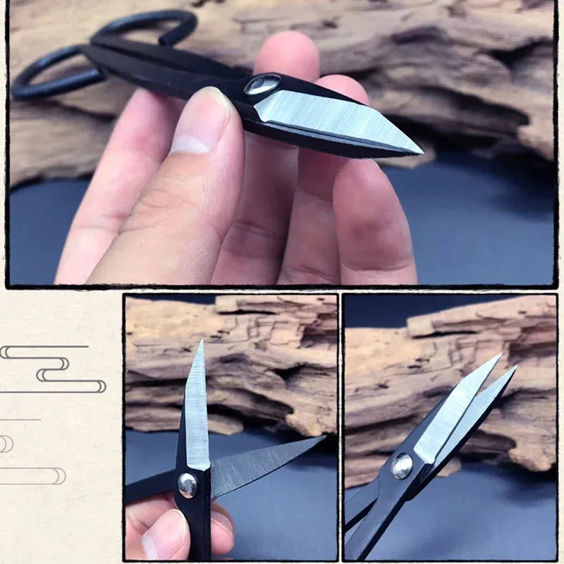 Steel bonsai pruning scissors held in hand, open silver blades on black handle