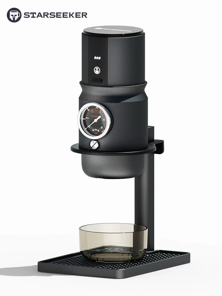 Starseeker black manual espresso maker with integrated pressure gauge and glass cup on a modern stand.