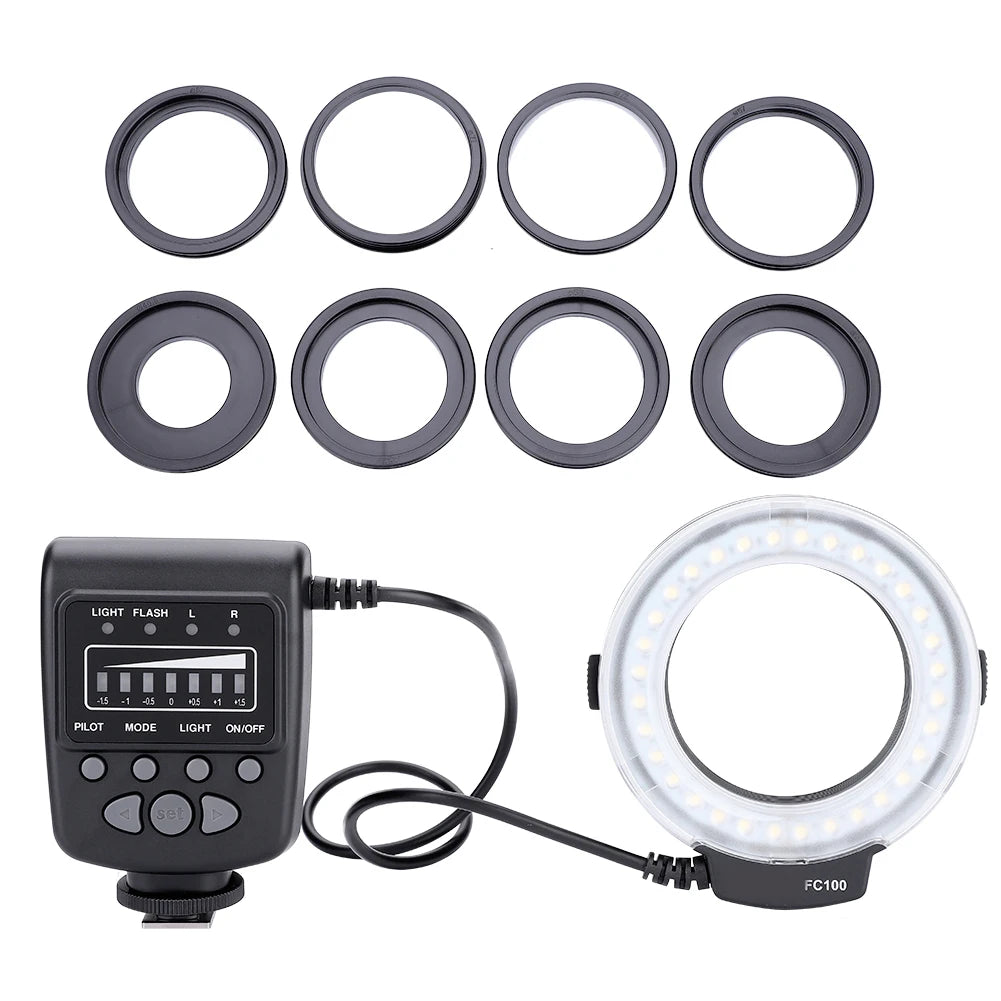 FC100 macro ring flash with controller unit and eight black circular adapter rings for camera lens mounting.