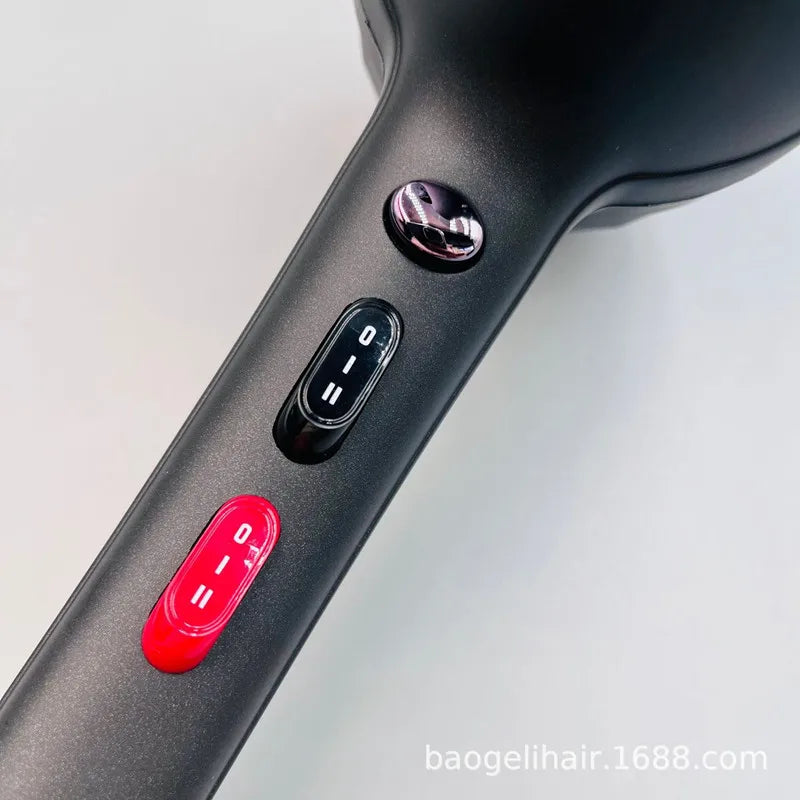 Matte black 2600W professional hair dryer handle with adjustable heat/speed settings and red button controls.