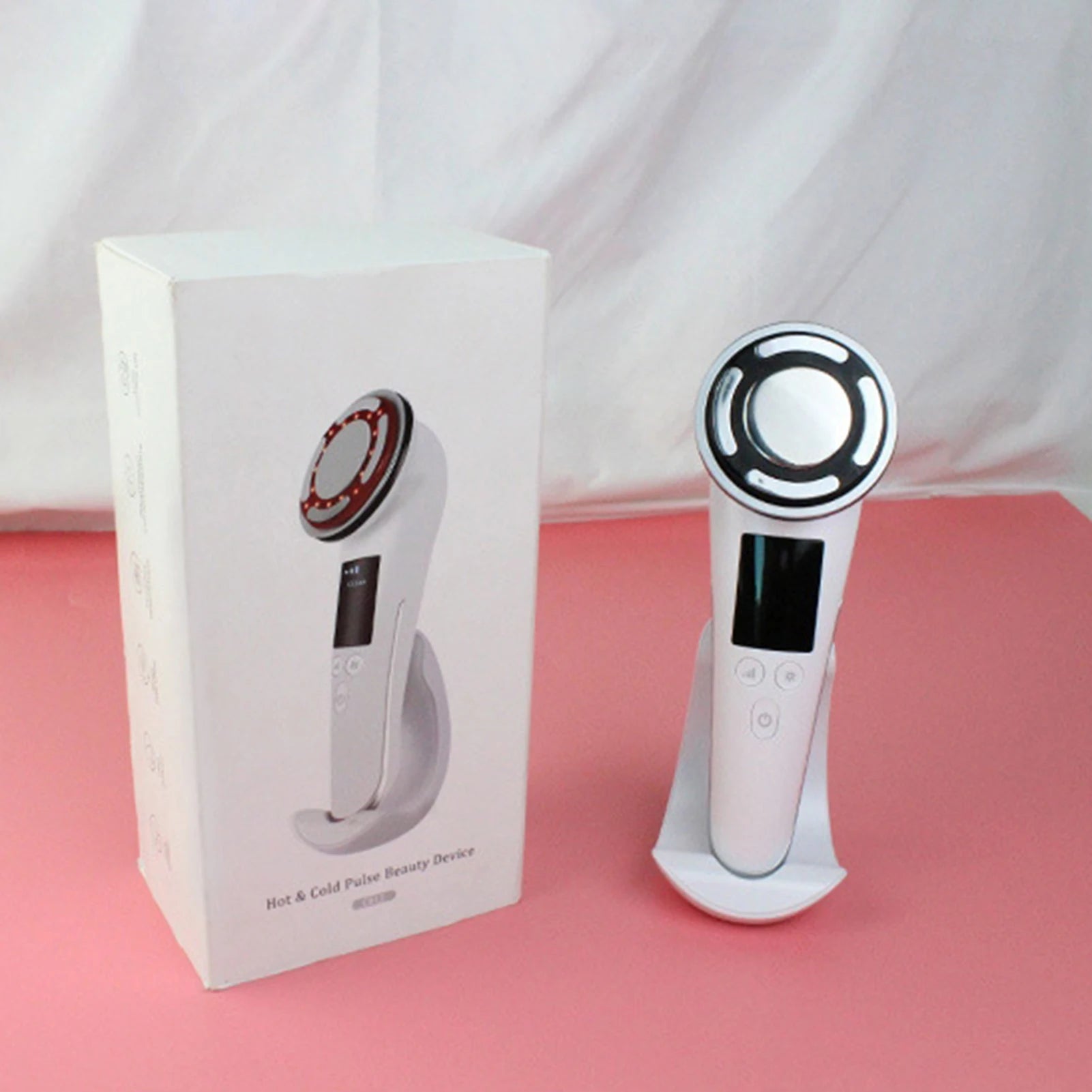 White hot and cold pulse facial beauty device with charging base, EMS vibration, and LED light for skin rejuvenation.