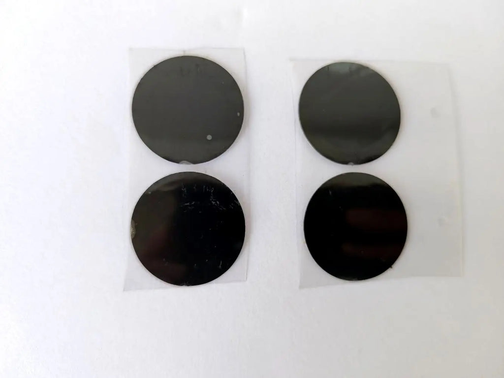 Four 28mm black circular film stickers for Vmax HIFU cartridge replacement, shown on clear adhesive backing.