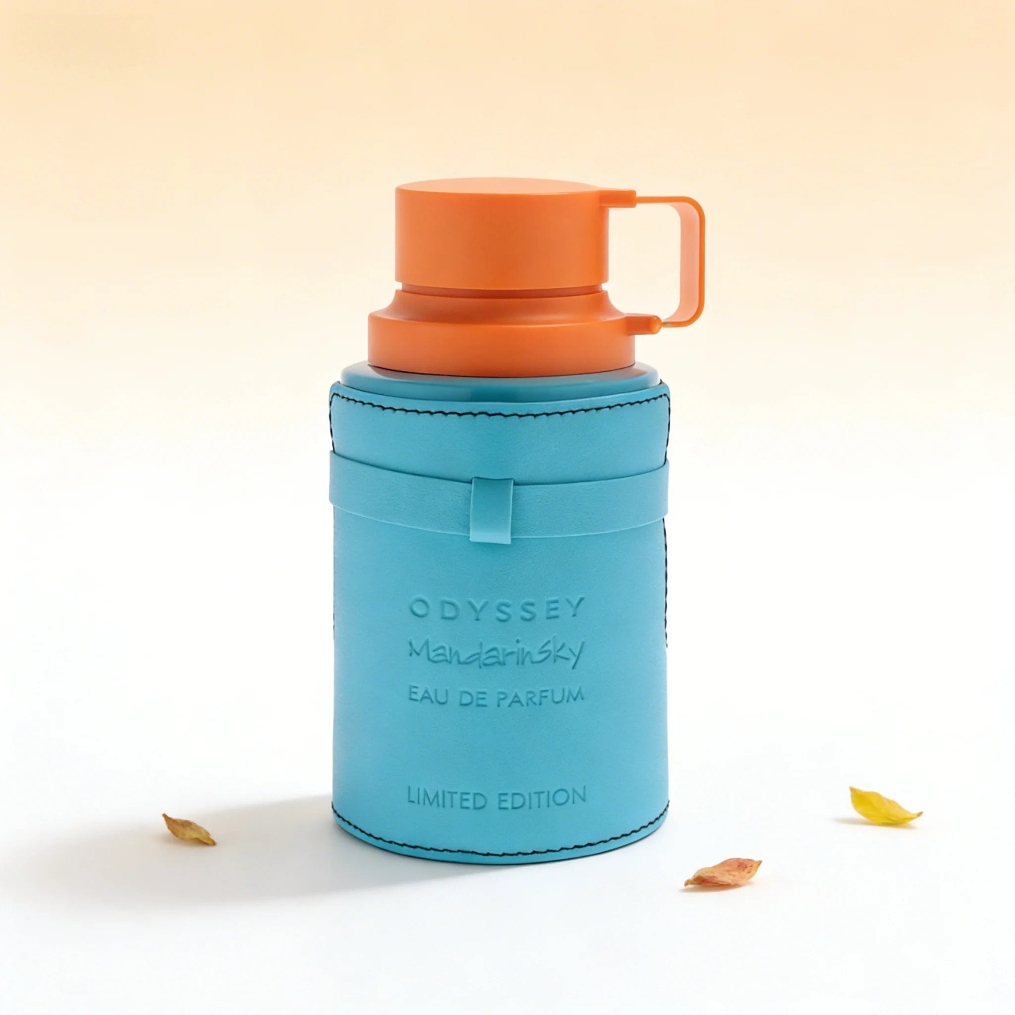 Odyssey Mandarinsky eau de parfum in a turquoise leather-wrapped cylindrical bottle with an orange plastic cap.