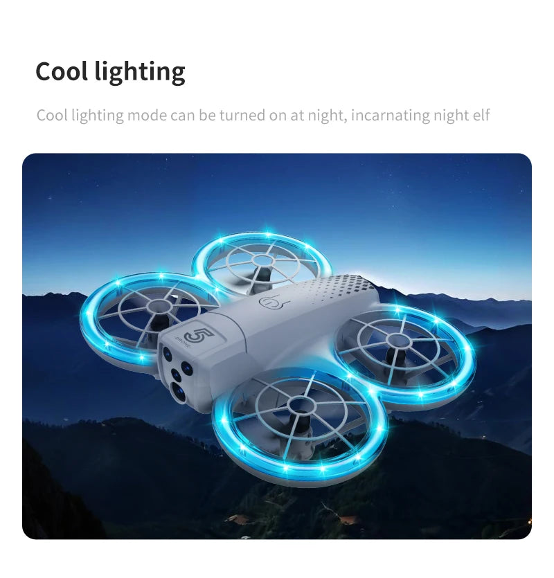 Small white quadcopter drone with four glowing blue LED propeller guards, hovering against a dark mountain landscape.