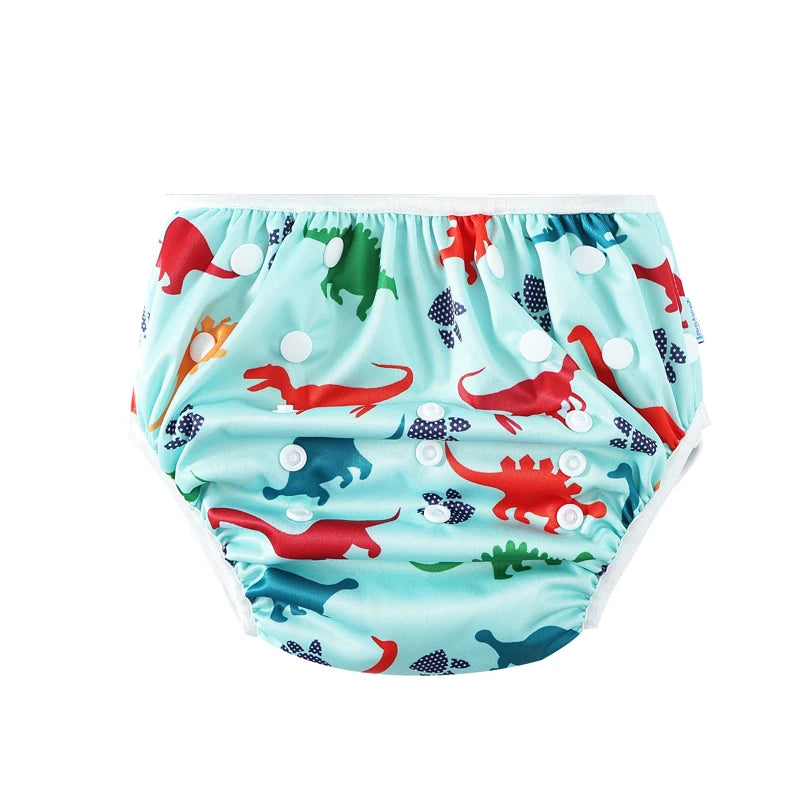 Reusable cloth baby diaper with adjustable snaps and colorful dinosaur print on a light blue background.