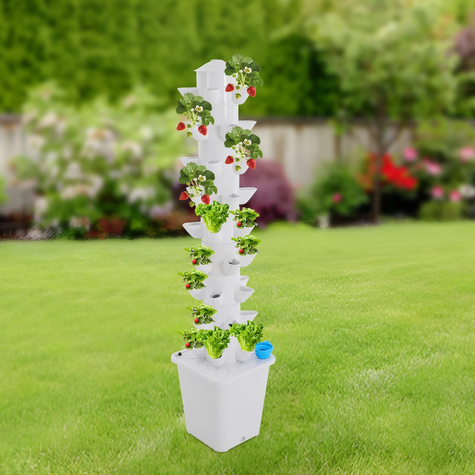 White vertical hydroponic planter tower with mixed seedlings and blue water inlet