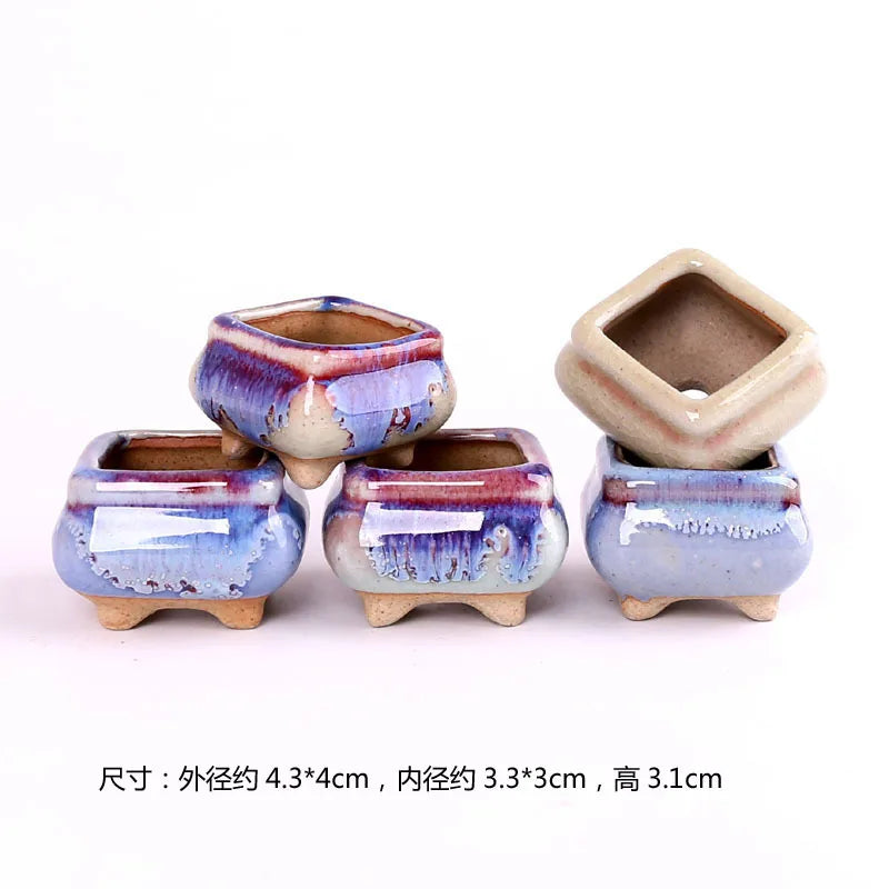 Cluster of mini ceramic ice-crack succulent pots in blue glaze with tan feet