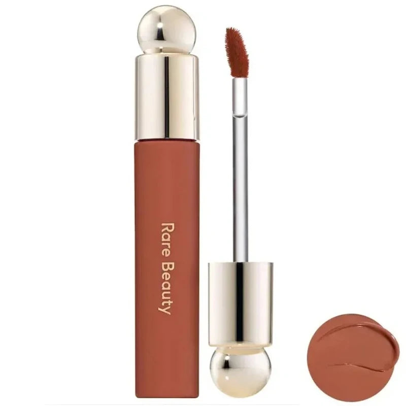 Rare Beauty Soft Pinch Tinted Lip Oil with applicator and brown glossy swatch, moisturizing long-lasting lip makeup.