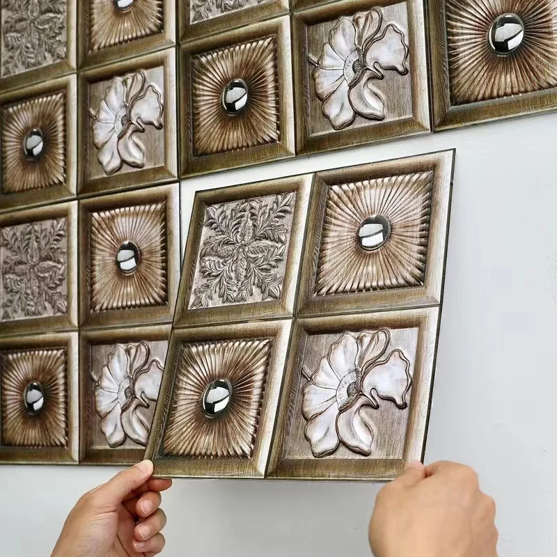 Decorative peel-and-stick tile backsplash squares in bronze with relief flowers and medallions