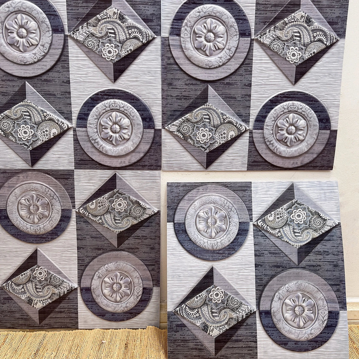 Decorative backsplash tiles with circular medallion and geometric pattern in gray and dark charcoal tones (12 in x 12 in).