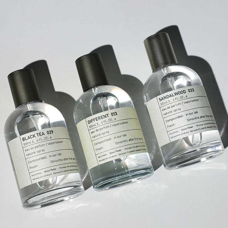 Alice Peter unisex 100ml EDP perfume set in round glass bottles, featuring Sandalwood, Black Tea, and Different scents.