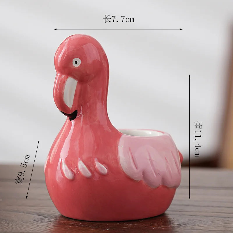 Red animal-shaped ceramic flower pot with white inner rim and cartoon eye
