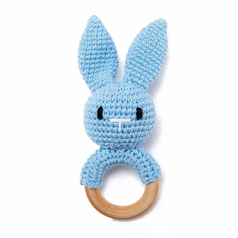 Blue crochet bunny baby teething ring with natural wood for soothing sore gums.