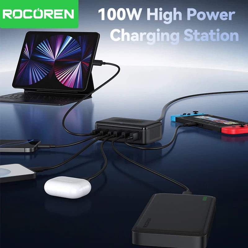 Black rectangular Rocoren 6-port GaN charging station powering multiple devices on a dark reflective surface.